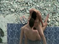 Voyeur cam captures an amateur couple having sex on the beach